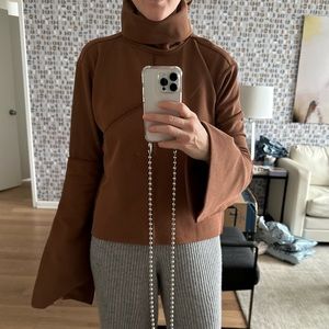 Brown turtleneck knit with trumpet sleeves